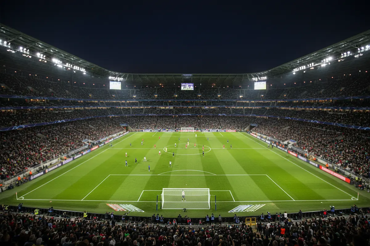 Stade de football européen illuminé la nuit pour un match de Ligue des Champions